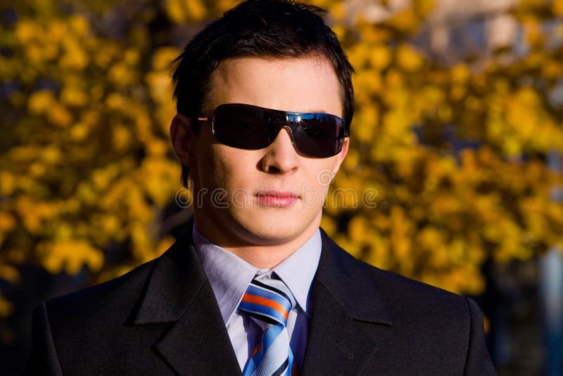 Portrait of young businessman in sunglasses