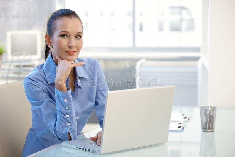 Portrait of young businesswoman with computer