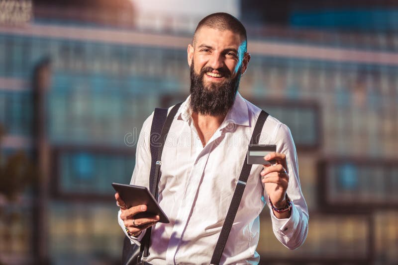 Young caucasian businessman holding a tablet and credit card stock image Young caucasian businessman holding a tablet and credit card stock image
