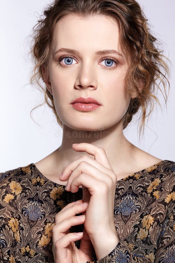 Portrait of a young caucasian woman in vintage retro dress and wavy hair on a gray background stock photos Portrait of a young caucasian woman in vintage retro dress and wavy hair on a gray background stock photos