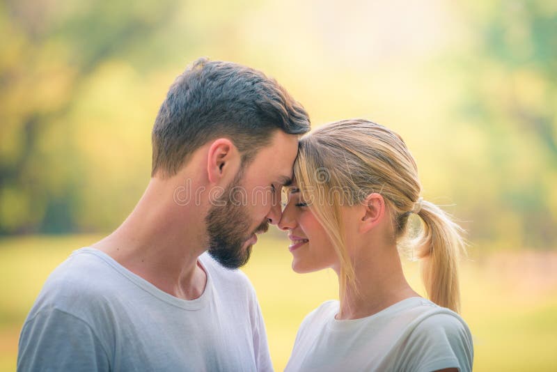 Portrait of Young couple enjoying in the park at sunset. Concept romantic and love. Warm tone.