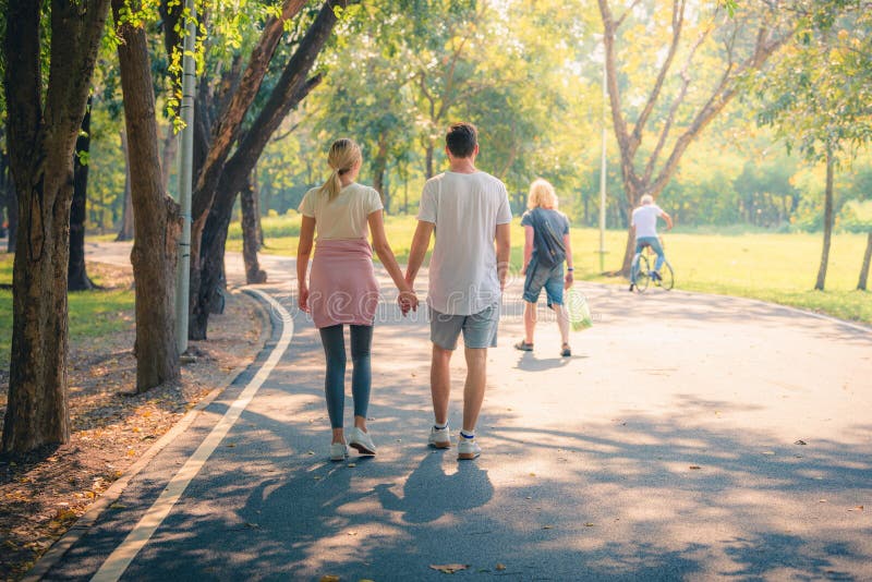 Portrait of Young couple enjoying in the park at sunset. Concept romantic and love. Warm tone.