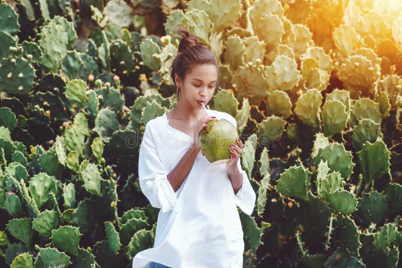 Afro girl drinking coco water from coconut royalty free stock images Afro girl drinking coco water from coconut royalty free stock images