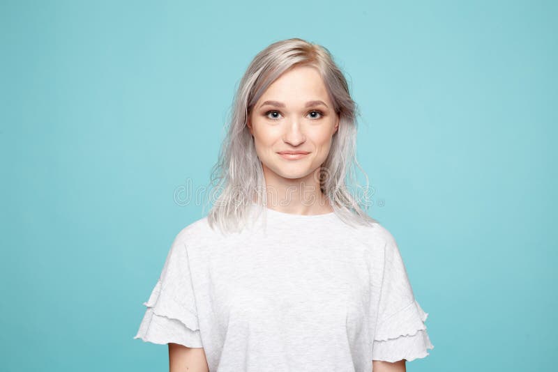Portrait of young female in the white t-shurt in the blue background. royalty free stock photos Portrait of young female in the white t-shurt in the blue background. royalty free stock photos