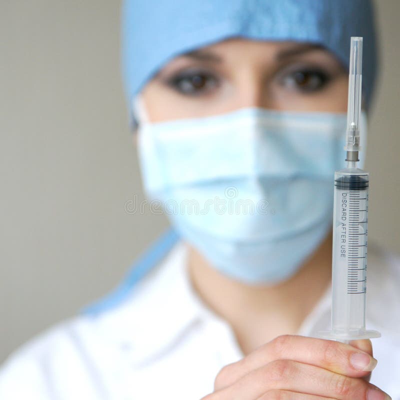 Portrait of a young female woman holding a syringe