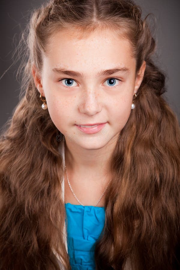 Portrait of a young girl with brown curly hair