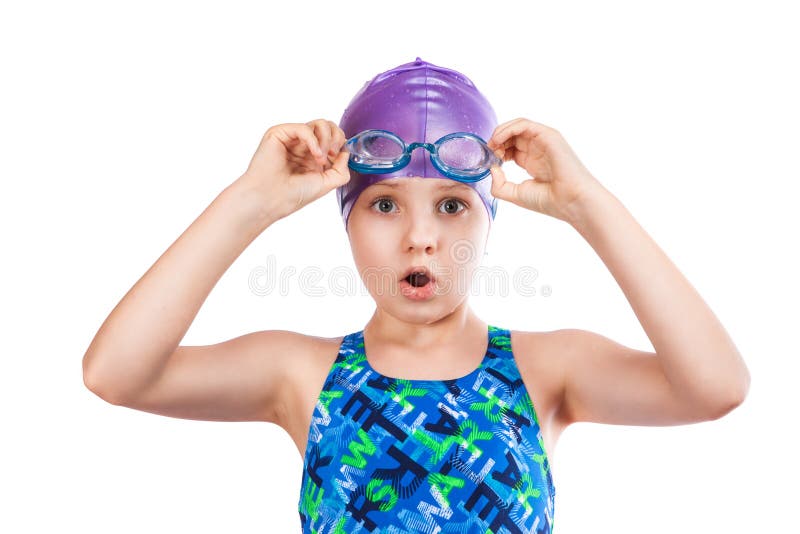 Portrait of a young girl in goggles and swimming cap. surprised girl