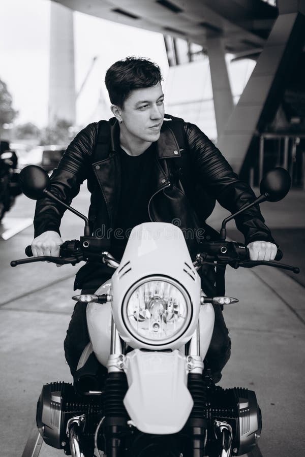 Portrait young guy posing on the motorcycle, fashion men royalty free stock photography Portrait young guy posing on the motorcycle, fashion men royalty free stock photography