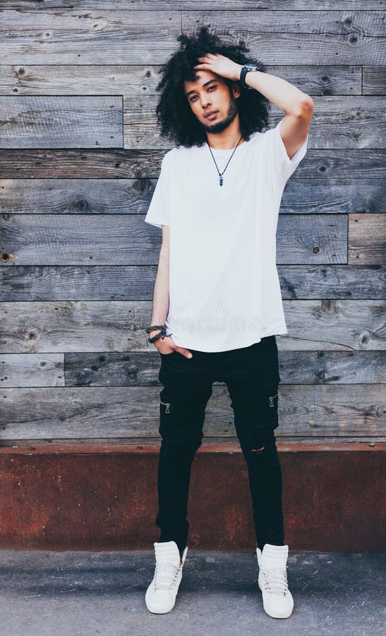 Portrait young handsome fashion bearded afro hair model black man in urban. Rest and relax. Dressed in a white t-shirt stock photos Portrait young handsome fashion bearded afro hair model black man in urban. Rest and relax. Dressed in a white t-shirt stock photos