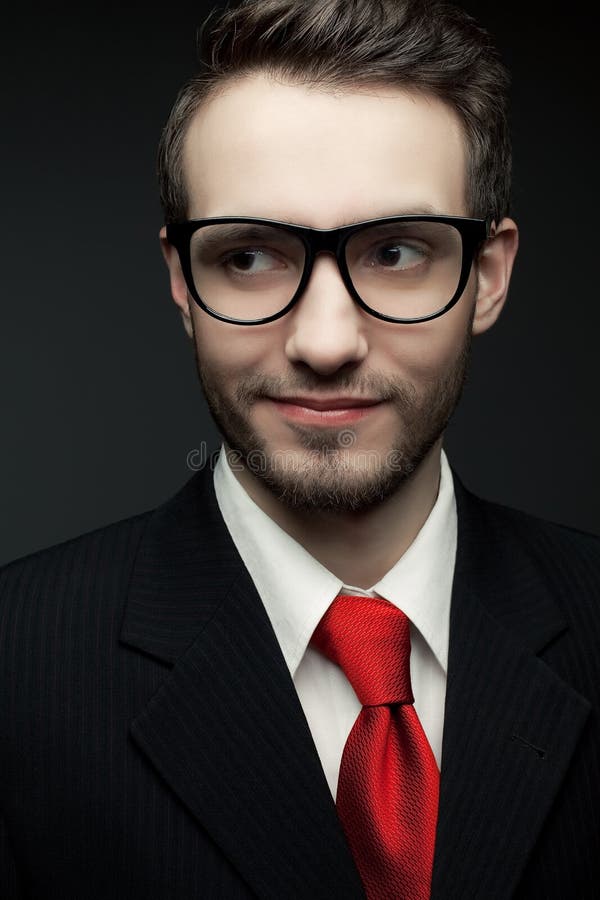 Portrait of young handsome man (businessman) in black suit