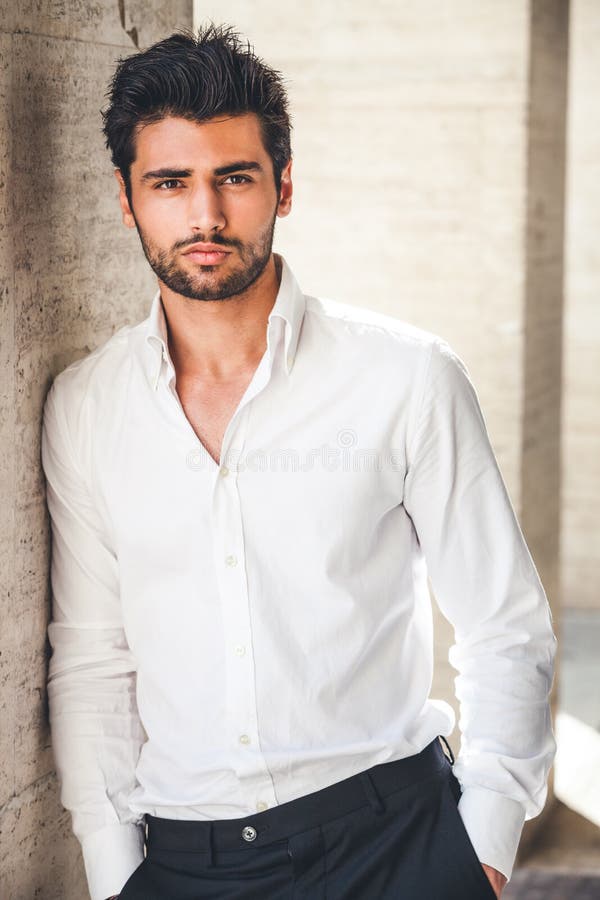 Portrait of young handsome man in white shirt outdoor.