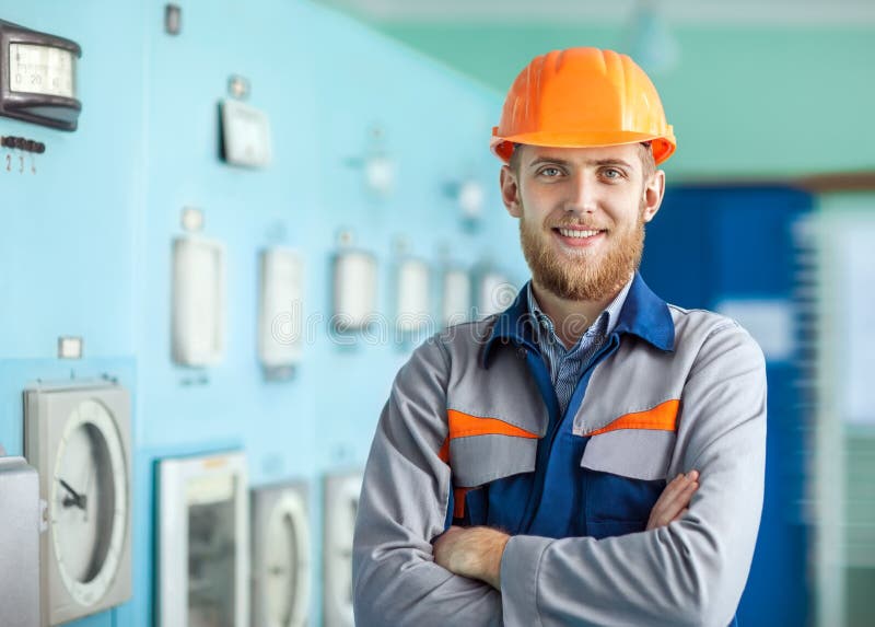 Portrait of young happy engineer at control room stock photo