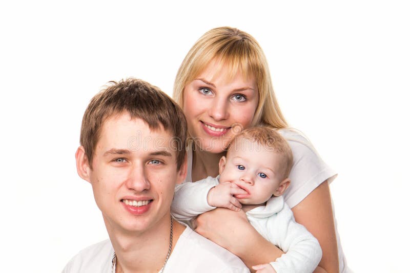 Portrait of a young happy family: mother, father and baby smiling