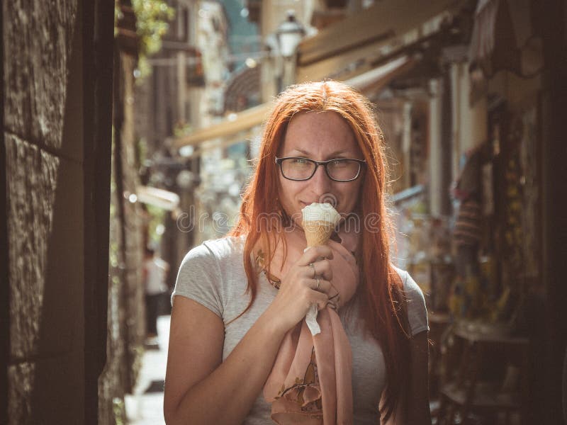 Portrait of young happy woman eating ice-cream, outdoor, Sorento, Italy stock photos Portrait of young happy woman eating ice-cream, outdoor, Sorento, Italy stock photos