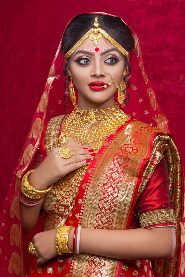 Portrait Of Young Indian Bride Wearing Gold Jewelry And Red Sari In Wedding Stock Image Image 
