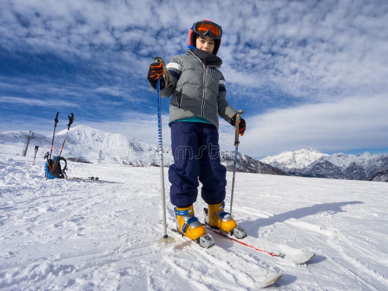 Portrait of young kid skier on ski slope