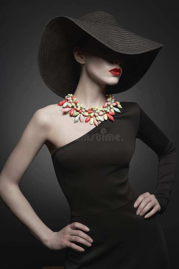 Portrait of young lady with black hat and evening dress