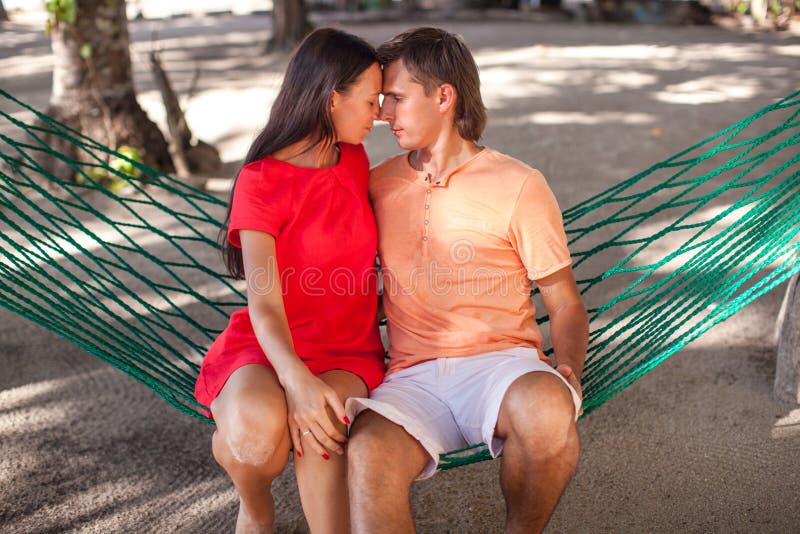 Portrait of Young loving couple in a hammock at