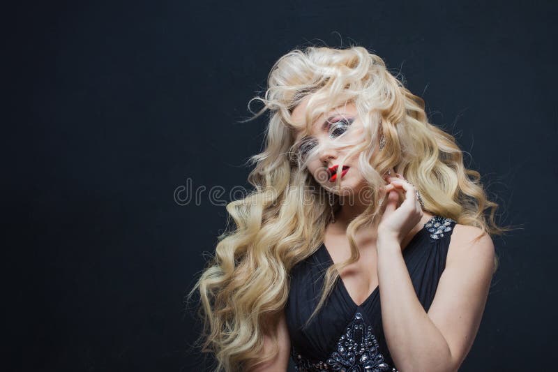 Portrait of a young luxurious blonde with long curls. royalty free stock images Portrait of a young luxurious blonde with long curls. royalty free stock images