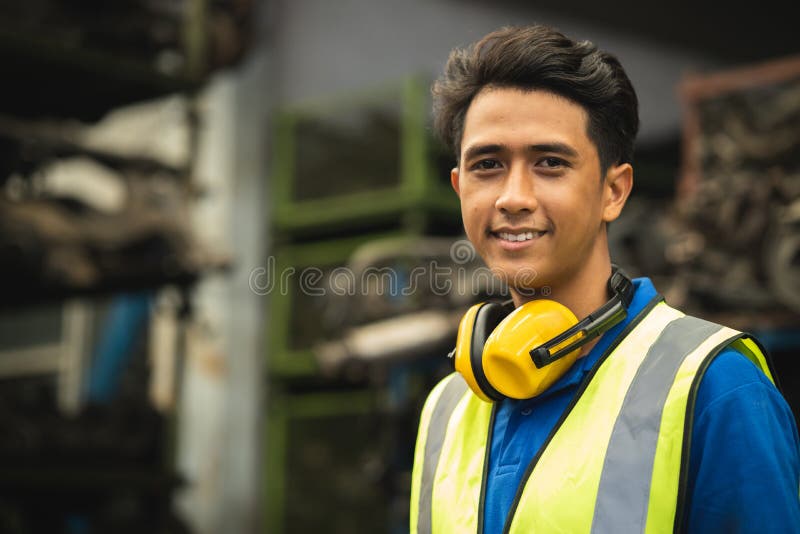 Portrait young male worker engineer working in heavy industry with safety happy smile looking camera royalty free stock photos