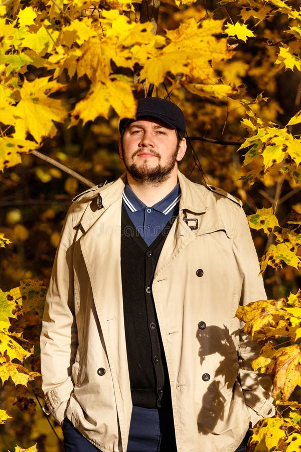 Portrait of young man in autumn forest stock photo Portrait of young man in autumn forest stock photo