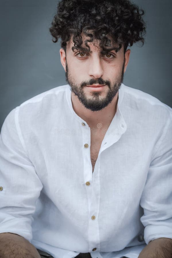 Portrait of a Young Man with Beard and Curly Hair, Who Smiles Slightly while Looking in Front of Him Stock Photo - Image of happy, businessman: 229393836 Portrait of a Young Man with Beard and Curly Hair, Who Smiles Slightly while Looking in Front of Him Stock Photo - Image of happy, businessman: 229393836