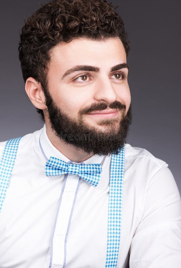 Portrait of a young man with a beard and mustache. Stylish appearance, bow tie stock photo Portrait of a young man with a beard and mustache. Stylish appearance, bow tie stock photo