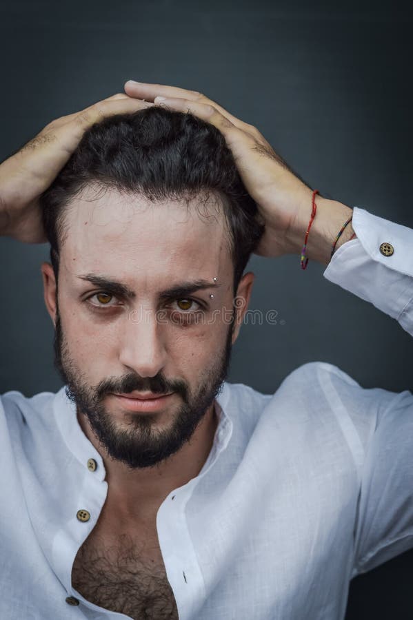 Portrait of a Young Man with Beard, Who with His Hands Holds His Curly Hair  Covering His Forehead Stock Image - Image of beard, hair: 229393707