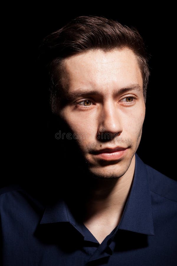 Portrait of Young Man in His 20s on Black Background Stock Image