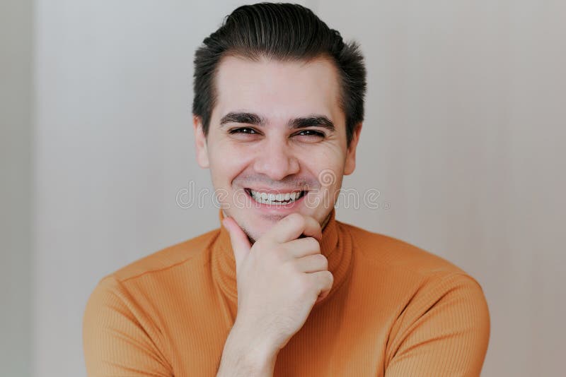 Portrait of a Young Man. the Man Puts His Hands Under His Chin and