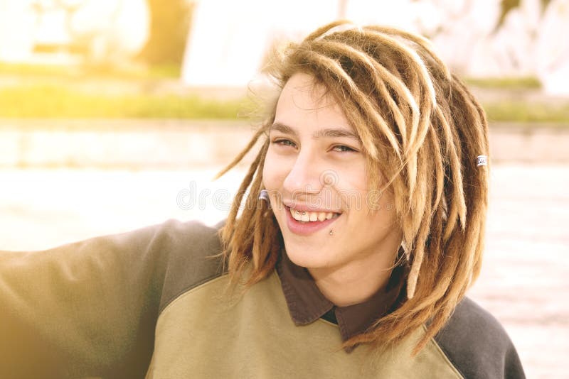 Portrait of a young man with rasta hairs