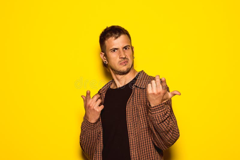 Portrait of a young man shrugging his shoulders stock image Portrait of a young man shrugging his shoulders stock image