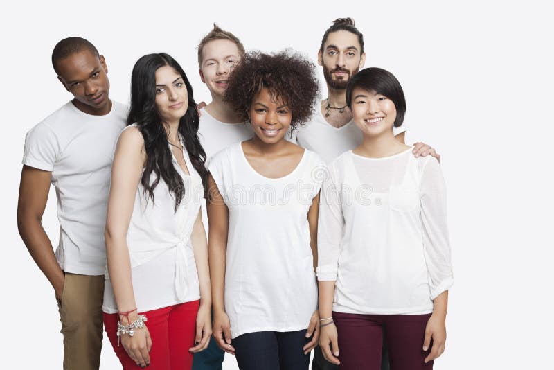 Portrait of young multi-ethnic friends in casuals smiling together over white background