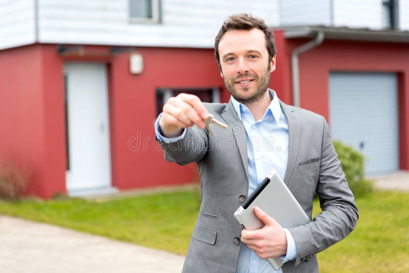 Young Real Estate Agent Worker Working with Laptop and Tablet at Table