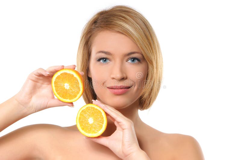 Portrait of a young redhead woman with oranges