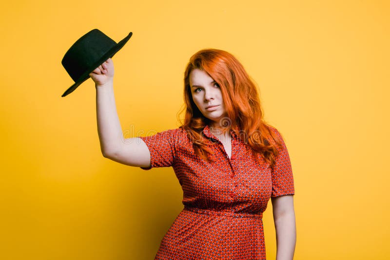 Portrait Of Young Redhead Woman In Red Dress With Black Hat Bright