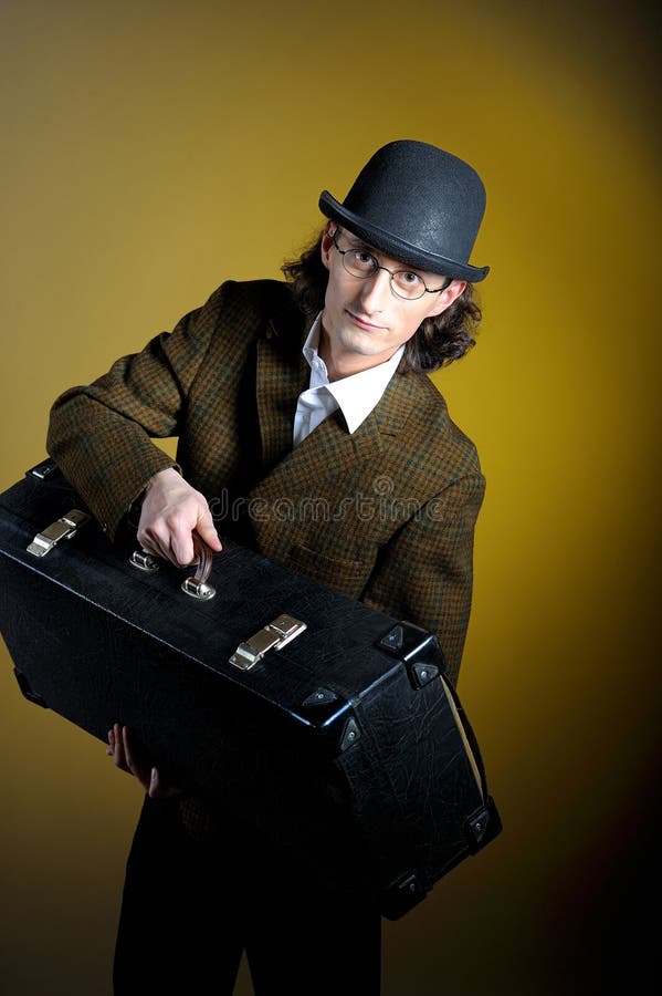 Portrait of young retro gentleman with luggage