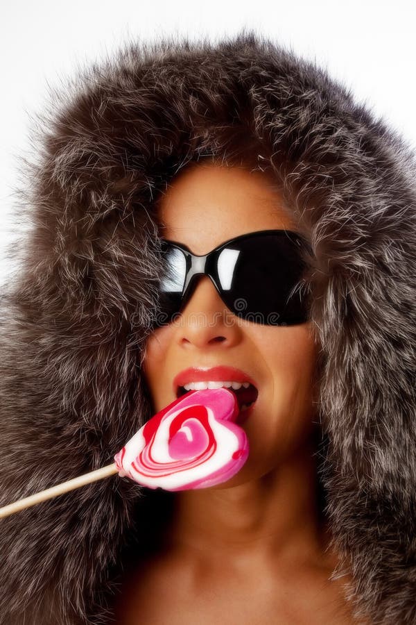 Portrait of young woman eating candy