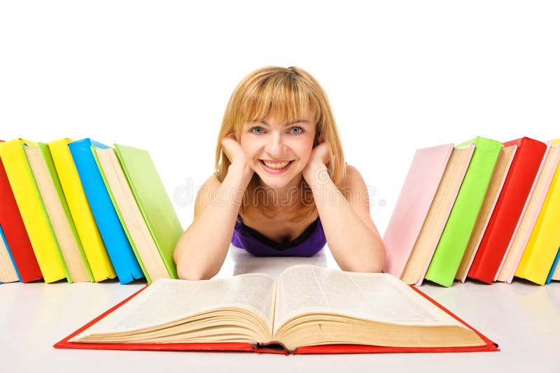 Portrait of a young student lying and reading a book