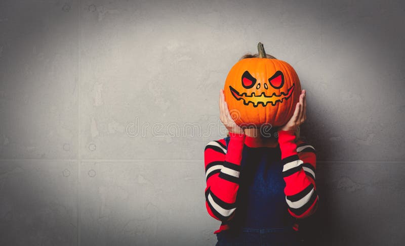 Young girl with halloween pumpkin