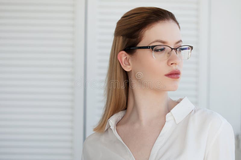 Portrait of a young stylish business woman in a white shirt and glasses. royalty free stock image Portrait of a young stylish business woman in a white shirt and glasses. royalty free stock image
