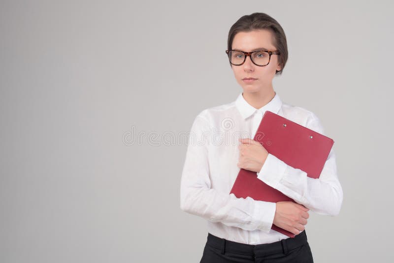 Young serious business girl holds folder isolated royalty free stock image Young serious business girl holds folder isolated royalty free stock image