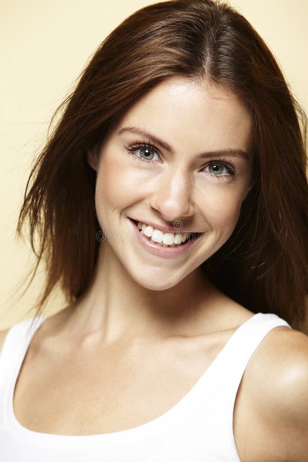 Portrait Of A Young Woman, Against Beige Background Stock Photo - Image ...