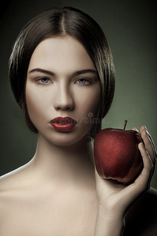 Portrait of young woman with apple stock images Portrait of young woman with apple stock images