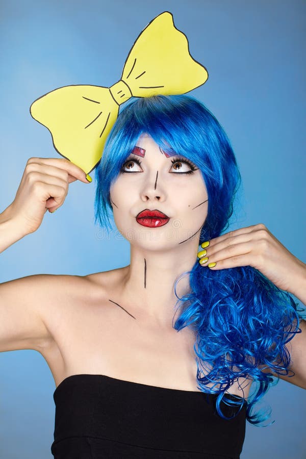 Portrait of young woman in comic  pop art make-up style. Girl with yellow bow-tie in hands