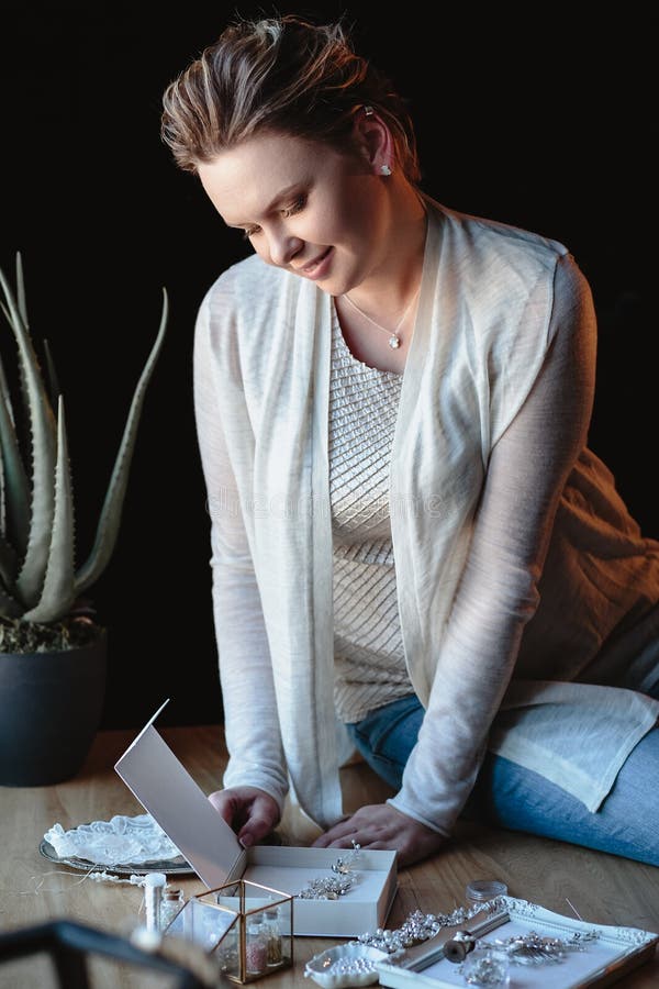 Portrait of woman, creating wedding jewelry, workplace of decorator. Woman`s hands in a process of creation stock images Portrait of woman, creating wedding jewelry, workplace of decorator. Woman`s hands in a process of creation stock images