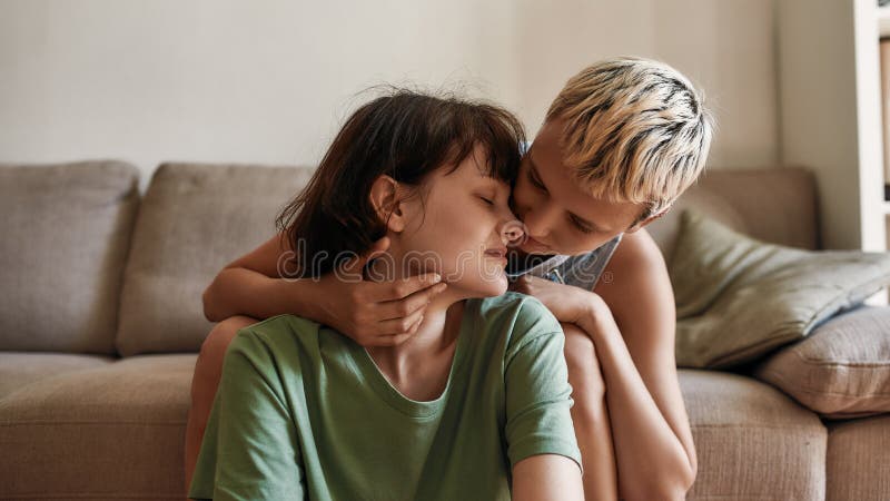 Portrait of Young Woman Cuddling with Her Girlfriend at Home picture