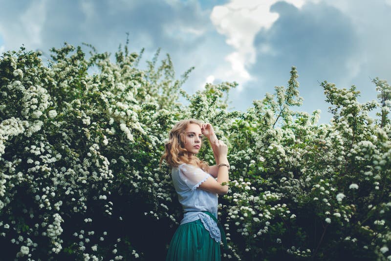 Woman in spring blossom. Young naturally beautiful woman near th stock photos Woman in spring blossom. Young naturally beautiful woman near th stock photos