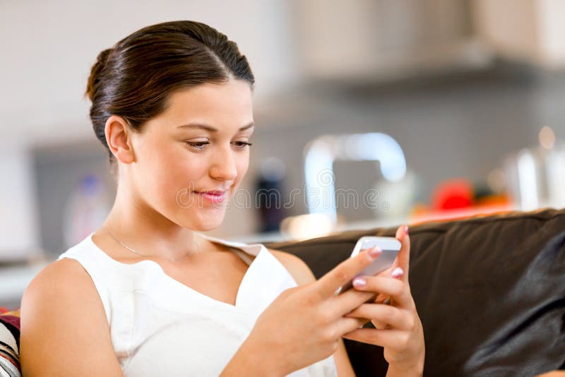 Portrait of young woman holding phone