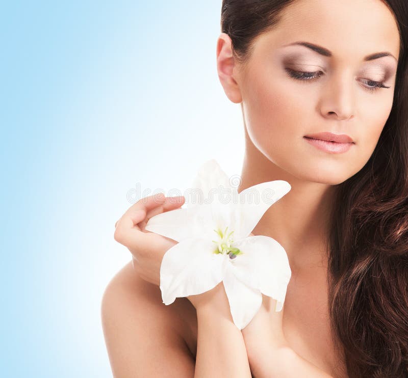 Portrait of a young woman holding a whit flower